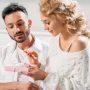 Charming girl sitting on sofa with boyfriend and holding gift